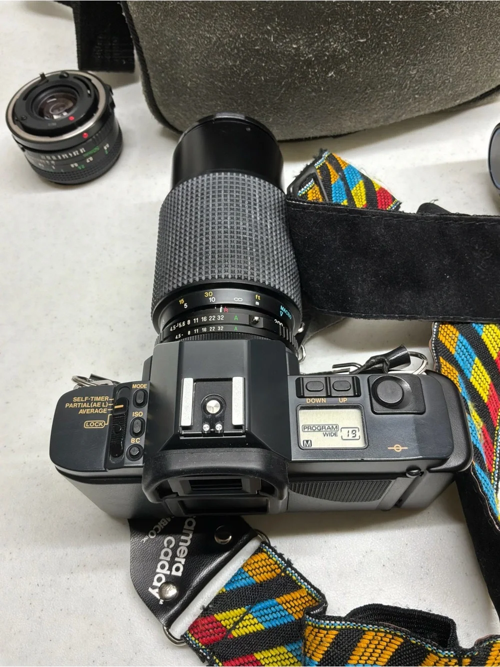 Canon T70 35mm SLR Camera with Black Telephoto Lens and Accessories